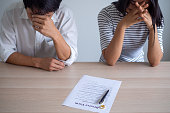 Couple is feeling stressed after agreeing to sign a divorce certificate. Concepts of lovers having family problems, divorce or quarrels or conflicts