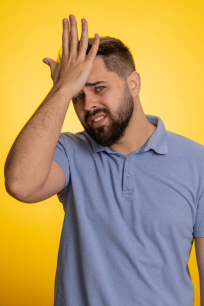 istock Upset confused young man making face palm gesture, feeling bored, disappointed in result, bad news 1487945492