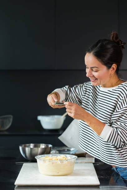 istock Woman making photo for a social media while cooking pie 1487947372