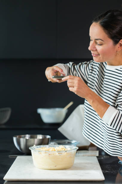 istock Woman making photo for a social media while cooking pie 1487947432