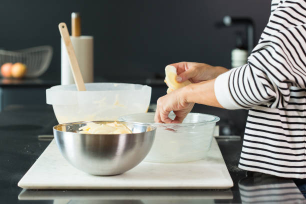 istock Woman hands putting apples while cooking apple pie 1487947835