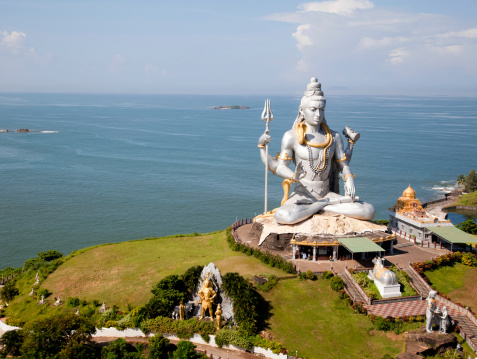 huge idol of Lord shiva (shiv ji - God) under blue sky  , Murudeshwara Temple : This temple is built on the Kanduka Hill which is surrounded on three sides by the waters of the Arabian Sea.
