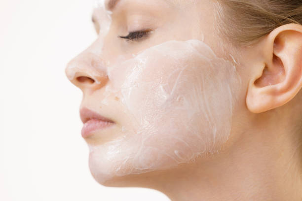istock Girl with cream moisture cosmetic on face 1487956820