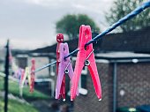 Clothes pegs on a washing line on a rainy morning