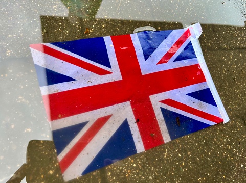 Union Jack flag in puddle