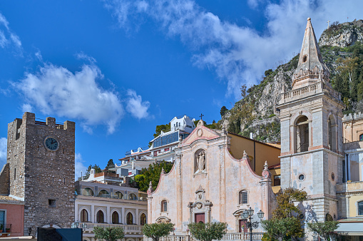 Taormina, Italy - February 5, 2023: View of the  St. Giuseppe Church and the Clock Tower Gate