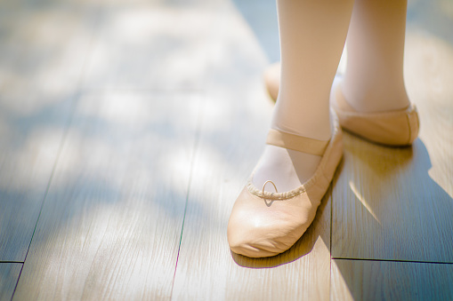 A teenager ballet dance practicing in ballet class, close up and shallow depth of field.