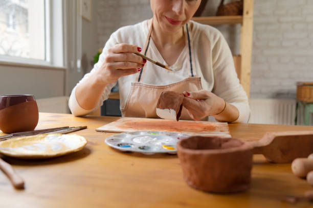 istock Woman painting a pottery 1487967877