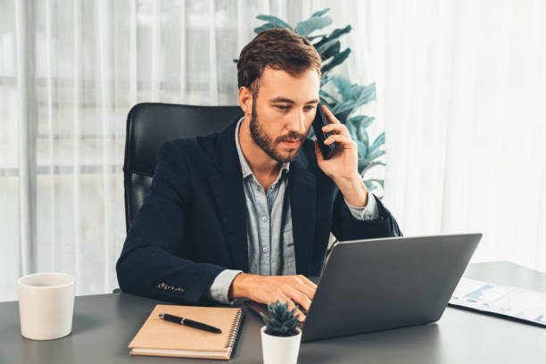 istock Hardworking and diligent businessman working on his laptop and phone. Entity 1487970712