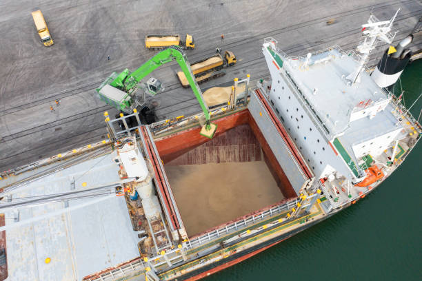 istock Loading grain into sea cargo vessel in commercial port. Aerial view. 1487972113
