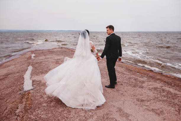 istock Newlyweds married couple on the ocean coast 1487974855