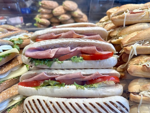 Lots of different sandwiches on the counter in the store.