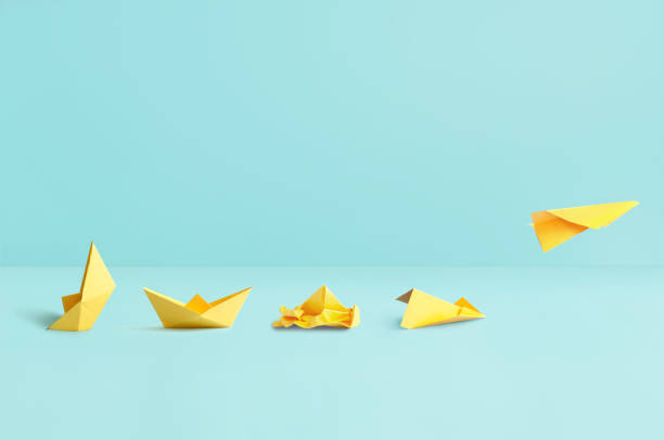 istock Sinking boat to paper airplane success concept 1487978096