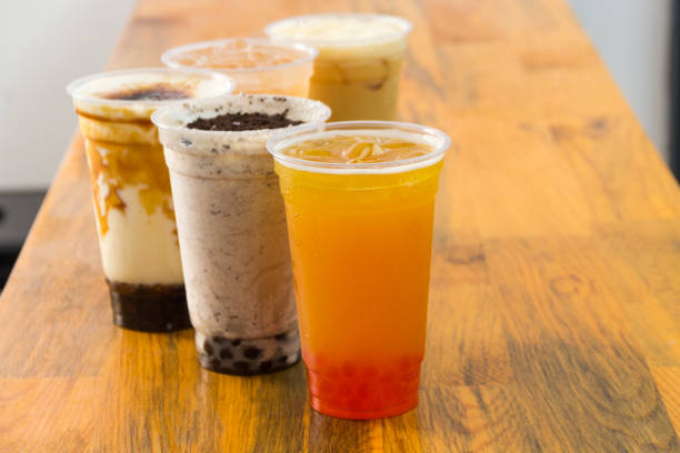 istock Fruit Bubble Teas - Pineapple, orange, strawberry and transparent Bubble Teas on the table 1487979776