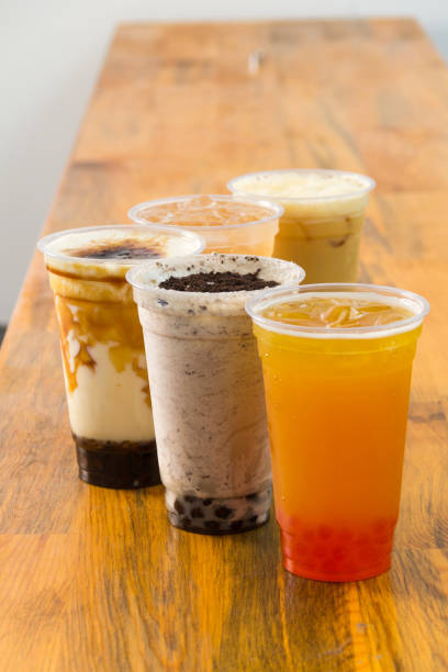 istock Fruit Bubble Teas - Pineapple, orange, strawberry and transparent Bubble Teas on the table 1487979780