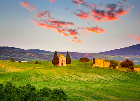 Beautiful landscape with chapel in Tuscany at sunset