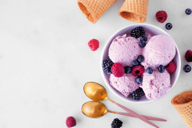 Field berry ice cream, top view with copy space on a marble background