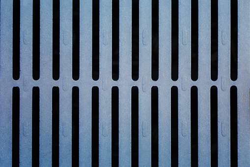 An up close images of a water grates lines and pattern