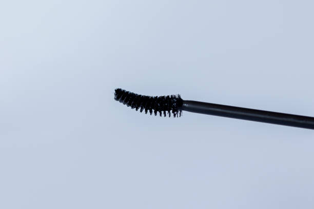 istock Black Mascara brush on white background, close-up 1487989353