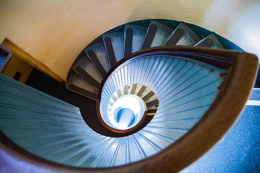 An old blue spiral staircase in an old lighthouse.