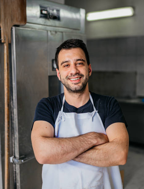 istock Happy baker next to the oven 1487990817