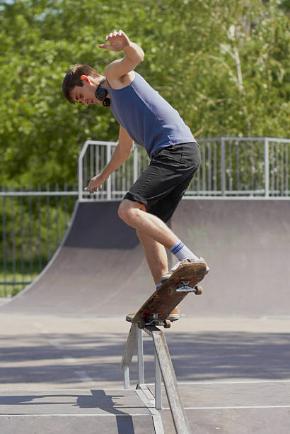 istock Skater doing crooked grind on fun-box in skatepark 148799119