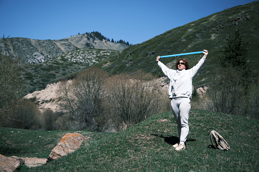 Woman is exercising in mountain valley