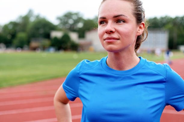 Portrait of a young woman resting after exercising  or run on stadium. Fitness and healthy lifestyle concept