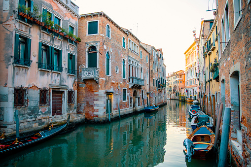 Venice, Italy water canal with rustic ancient buildings and boats