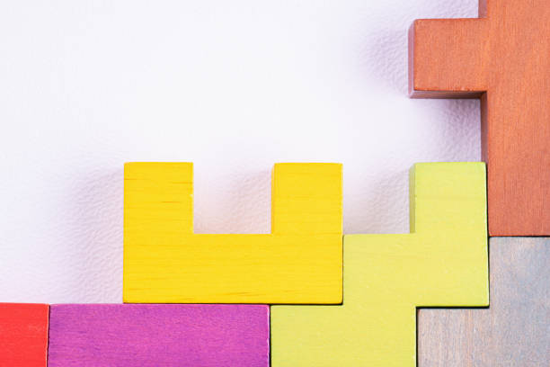istock Different colorful shapes wooden blocks on white background, flat lay, copy space. Geometric shapes in different colors, top view. 1487993340