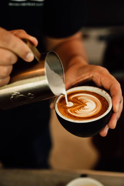 istock Barista expertly creates unique latte art on a  coffee 1487993502