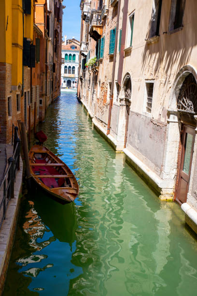 Small water canal between ancient houses in Venice, Italy