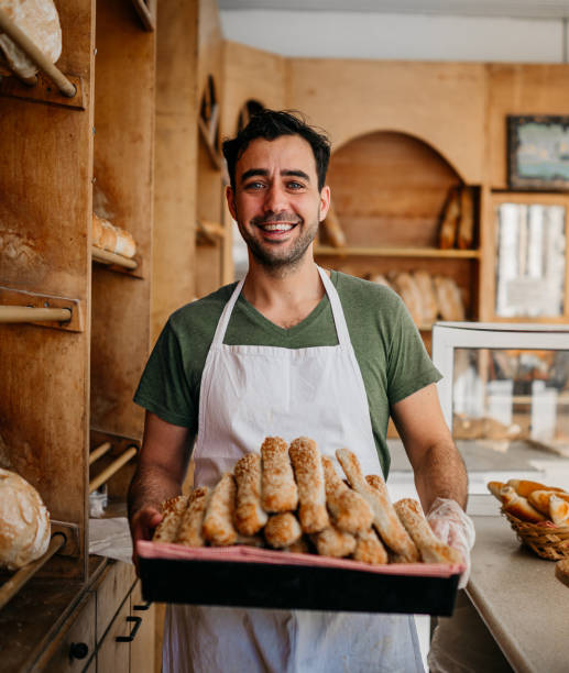 Baker with fresh pastries stock photo