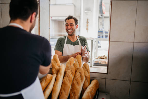 istock Bakery owners arranging bread in the bakery 1487994350