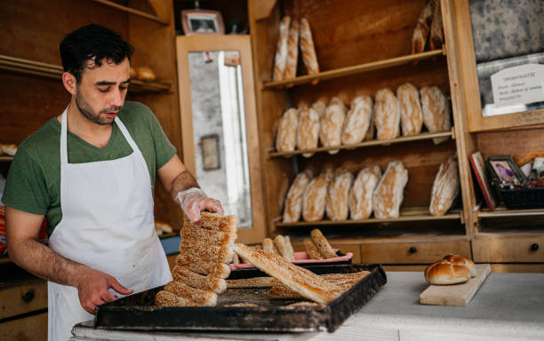 istock Handsome middle age male worker working in bakery 1487994438