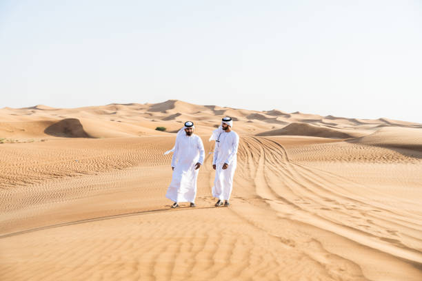 istock Two middle-eastern emirati men wearing arab kandura bonding in the desert 1487994803