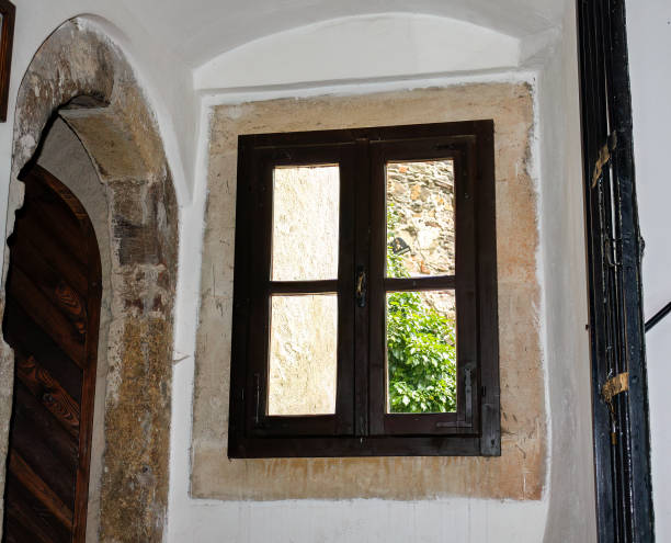 istock Light closed window in stone-frame. Outside with stone wall, green plan. Location: Lockenhaus, Austria. 1487994998