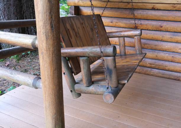 istock Log cottage and porch swing 1487995879