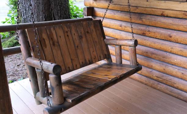 istock Log cottage and porch swing 1487995883