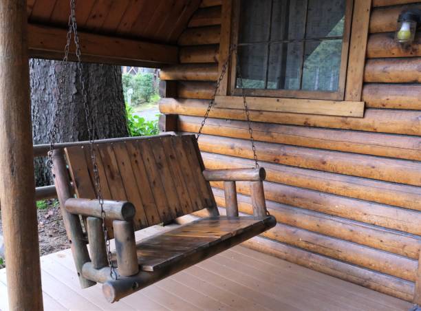 istock Log cottage and porch swing 1487995884
