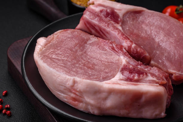 istock Raw pork on the bone or rib sliced with salt, spices and herbs 1488001840