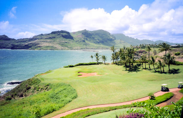 Vintage film photograph from the 1980s overlooking the volcanic mountains around Maui from a high angle view with the putting green of a gold course in the foreground on the tropical island of Maui, Hawaii.