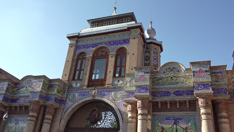 the facade of an old beautiful Persian government building