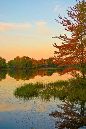 A colorful pond in fall at sunset Belgrade Maine