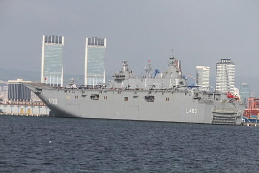 TCG Anadolu, built in Sedef Shipyard in Istanbul, is 230 meters (754 feet) in length and 32 m (105 ft) in width, and has an area of 9,200 square meters (99,028 sq-ft).\n\nSix helicopters can land or take off simultaneously, while uncrewed combat aerial vehicles can also be deployed at the ship's flight deck.\n\nThe ship, with a full-fledged hospital and two operation rooms, can host around 1,200 staff.\n\nIt has a capacity to carry 13 tanks, 27 marine assault vehicles, six armored personnel carriers, 15 trailers, and 33 various vehicles.
