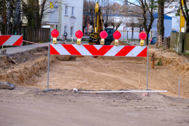 istock Road barrier at the road construction. Street construction with new communications. 1488010441