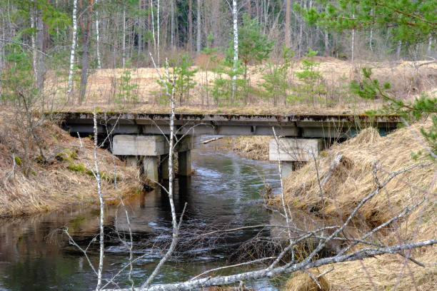 istock an old concrete bridge over a small river. Narrow gauge railway bridge. 1488010510
