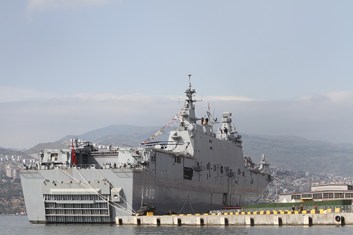 Navy frigate enters a harbour after offshore training exercises.