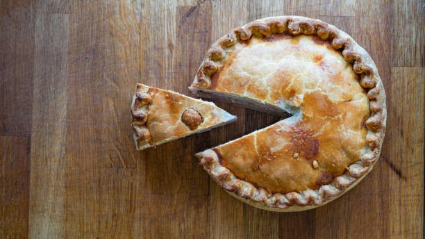 istock Savory Pork Pie Delights on Rustic Wooden Table top wiev 1488016811