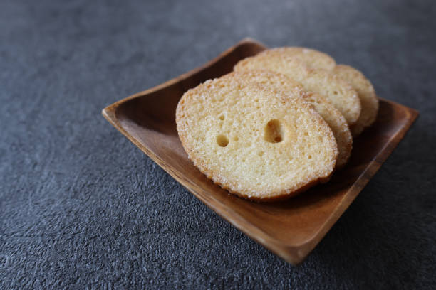istock Rusks on a wooden plate isolated on a gray background. 1488016923